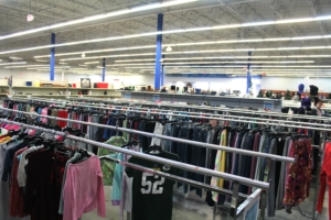 Aisles of clothes on hangers.