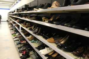 Shoes lined up on multiple shelves.