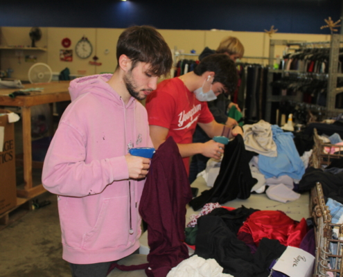 Youngstown State volunteers tagging clothing items.