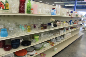 A shelf filled with household objects, including plates and vases.