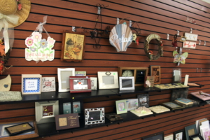 Picture frames are displayed on a back wall.